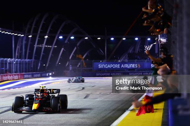 Race winner Sergio Perez of Mexico driving the Oracle Red Bull Racing RB18 passes his team celebrating on the pitwall during the F1 Grand Prix of...