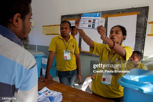 Election workers hold up ballots as the counting continues in the run-off Presidential elections on April 16, 2012 in Dili, East Timor. Voter turnout...