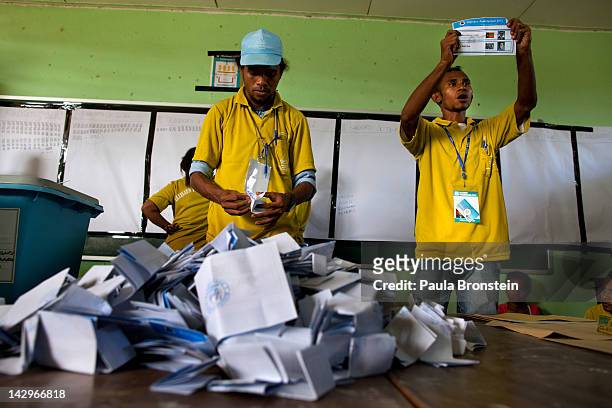 Election workers hold up ballots as the counting continues in the run-off Presidential elections on April 16, 2012 in Dili, East Timor. Voter turnout...