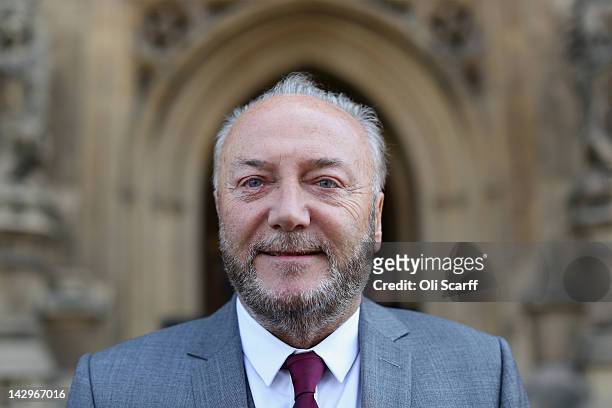 George Galloway poses for a photograph in front of the Houses of Parliament prior to being sworn in as a member of parliament on April 16, 2012 in...