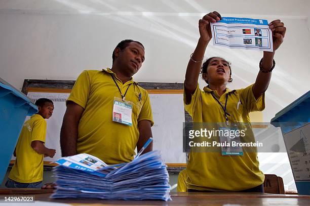 Election workers mark a tally board with votes counted as the counting continues in the run-off Presidential elections on April 16, 2012 in Dili,...