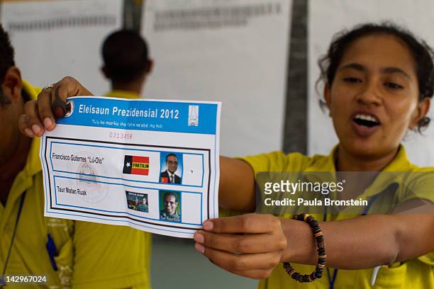 An election worker marks a tally board with votes counted as the counting continues in the run-off Presidential elections on April 16, 2012 in Dili,...
