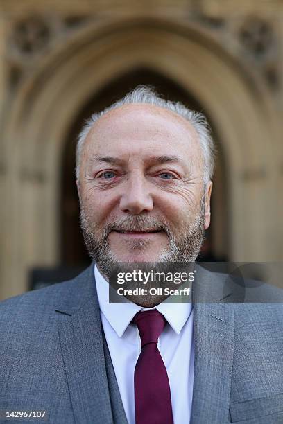 George Galloway poses for a photograph in front of the Houses of Parliament prior to being sworn in as a member of parliament on April 16, 2012 in...