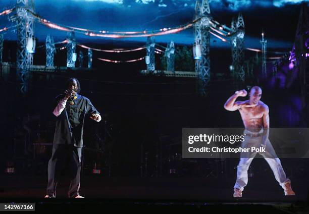 Rapper Snoop Dogg and a hologram of deceased rapper Tupac Shakur perform onstage during day 3 of the 2012 Coachella Valley Music & Arts Festival at...