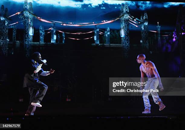 Rapper Snoop Dogg and a hologram of deceased rapper Tupac Shakur perform onstage during day 3 of the 2012 Coachella Valley Music & Arts Festival at...