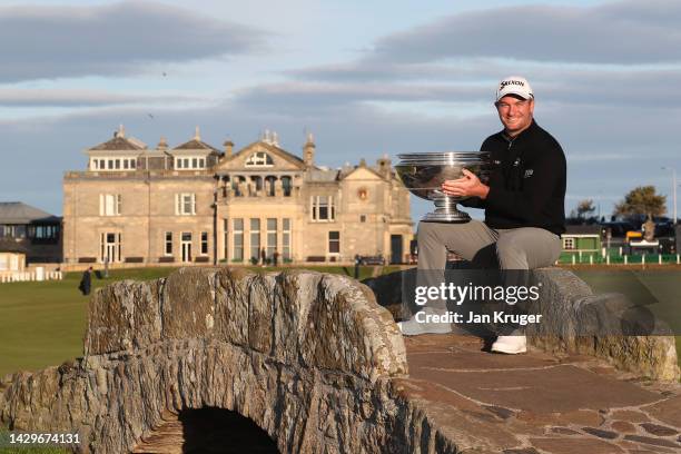 Ryan Fox of New Zealand poses with the trophy on the Swilcan Bridge on the 18th hole after winning the Alfred Dunhill Links Championship on the Old...