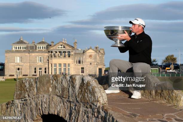 Ryan Fox of New Zealand kisses the trophy on the Swilcan Bridge on the 18th hole after winning the Alfred Dunhill Links Championship on the Old...