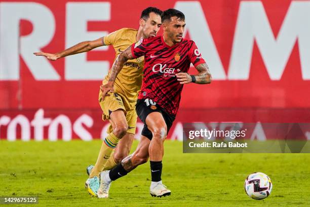 Antonio Sanchez of RCD Mallorca and Sergio Busquets of FC Barcelona competes for the ball during the LaLiga Santander match between RCD Mallorca and...