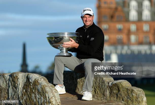 Ryan Fox of New Zealand poses with the trophy on the Swilcan Bridge on the 18th hole after winning the Alfred Dunhill Links Championship on the Old...