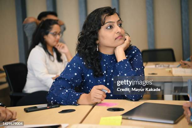 mid adult woman listening during a workshop in the classroom - mature student stock pictures, royalty-free photos & images