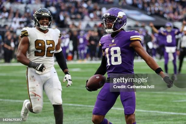 Justin Jefferson of the Minnesota Vikings scores a 3 yard touchdown in the fourth quarter during the NFL match between Minnesota Vikings and New...