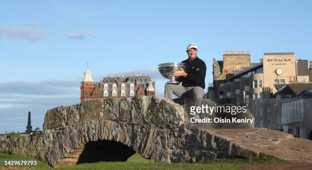 Ryan Fox of New Zealand poses with the trophy on the Swilcan Bridge on the 18th hole after winning the Alfred Dunhill Links Championship on the Old...