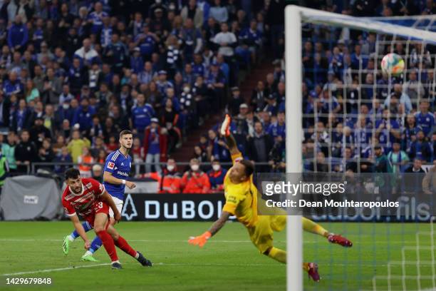 Tom Krauß of FC Schalke 04 scores their sides second goal past Rafał Gikiewicz of Augsburg during the Bundesliga match between FC Schalke 04 and FC...