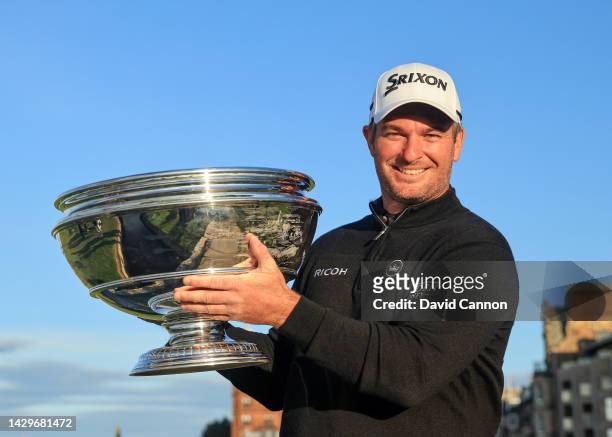Ryan Fox of New Zealand poses for a photograph with the trophy on The Swilcan Bridge after his win in the final round of the Alfred Dunhill Links...