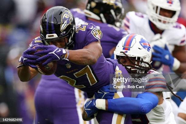 Dobbins of the Baltimore Ravens scores a touchdown while being tackled by Tremaine Edmunds of the Buffalo Bills in the first quarter at M&T Bank...