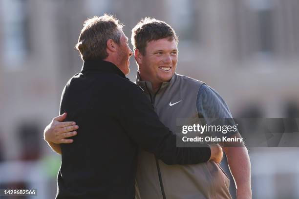 Callum Shinkwin of England and their playing partner, Alex Acquavella embrace on the 18th green on Day Four of the Alfred Dunhill Links Championship...