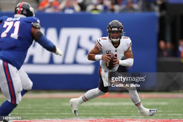Justin Fields of the Chicago Bears scrambles during the first quarter of the game against the New York Giants at MetLife Stadium on October 02, 2022...
