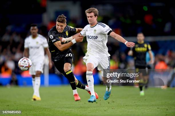 Patrick Bamford of Leeds United attempts to break the tackle of Jan Bednarek of Aston Villa during the Premier League match between Leeds United and...