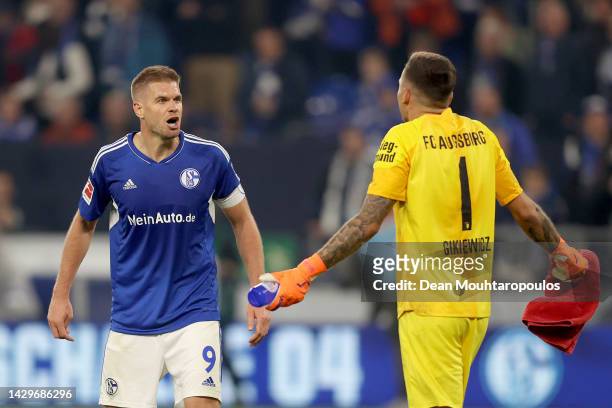 Simon Terodde of FC Schalke 04 and Rafał Gikiewicz of Augsburg interact following the Bundesliga match between FC Schalke 04 and FC Augsburg at...