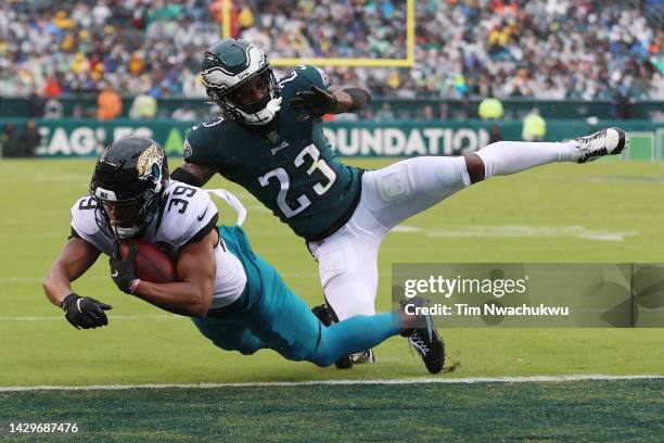 Jamal Agnew of the Jacksonville Jaguars dives for a touchdown past C.J. Gardner-Johnson of the Philadelphia Eagles during the first quarter at...