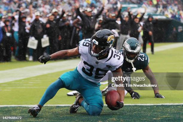 Jamal Agnew of the Jacksonville Jaguars dives for a touchdown past C.J. Gardner-Johnson of the Philadelphia Eagles during the first quarter at...