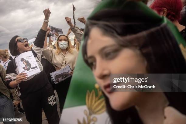 People hold signs and chant slogans during a protest against the death of Iranian Mahsa Amini and the government of Iran on October 02, 2022 in...