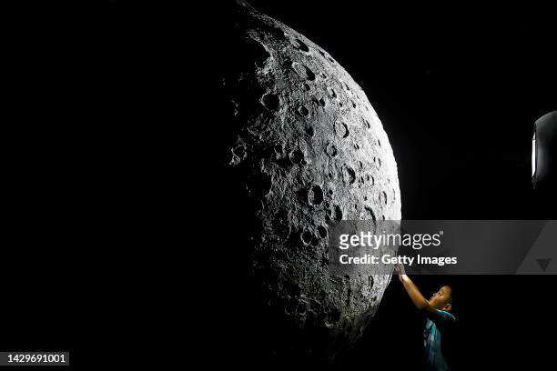 The boy touch to model of moon during Explore CASCI ART Exhibition on October 2, 2022 in Wuhan, Hubei province, China. China is celebrating its 73nd...
