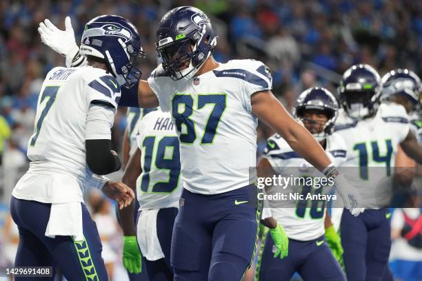 Geno Smith of the Seattle Seahawks celebrates with Noah Fant after scoring a touchdown during the first quarter of the game against the Detroit Lions...
