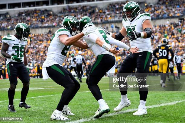Zach Wilson of the New York Jets celebrates with teammates after scoring a touchdown in the second quarter against the Pittsburgh Steelers at...
