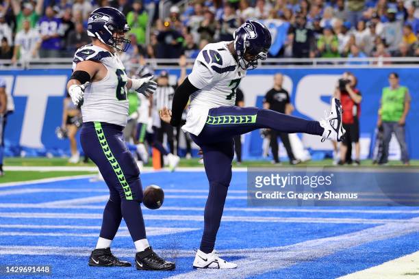 Geno Smith of the Seattle Seahawks celebrates after scoring a touchdown during the first quarter of the game against the Detroit Lions at Ford Field...