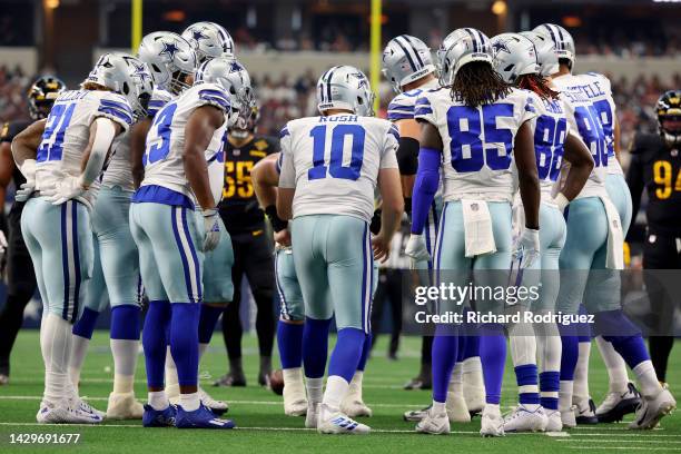 Cooper Rush of the Dallas Cowboys huddles his team during the first half against the Washington Commanders at AT&T Stadium on October 02, 2022 in...