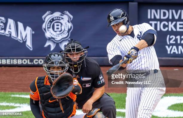 New York Yankees' Giancarlo Stanton hits a home run in the bottom of the first inning against the Baltimore Orioles at Yankee Stadium in the Bronx,...