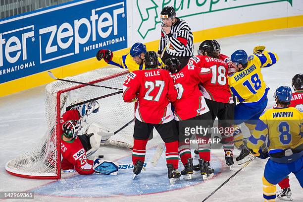 Hungarian goalkeeper Bence Balizs falls into the goal during the 2012 IIHF Ice Hockey World Championship Divison I, Group A match, between Hungary...