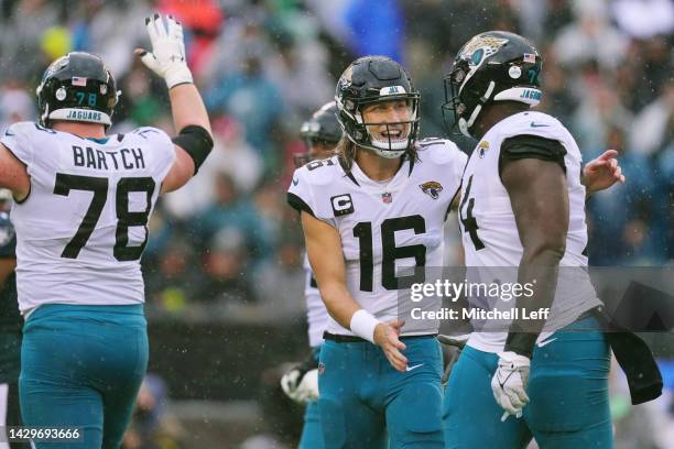 Trevor Lawrence of the Jacksonville Jaguars celebrates with Cam Robinson of the Jacksonville Jaguars after Lawerence's touchdown pass during the...