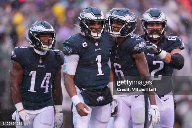 Kenneth Gainwell of the Philadelphia Eagles and DeVonta Smith of the Philadelphia Eagles celebrate with Jalen Hurts of the Philadelphia Eagles after...