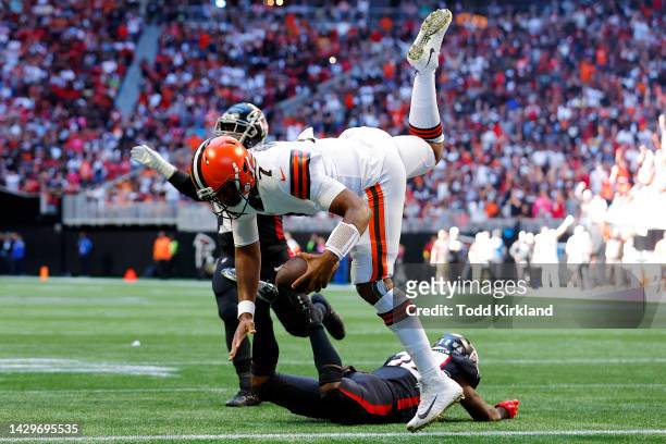 Jacoby Brissett of the Cleveland Browns leaps over Jaylinn Hawkins of the Atlanta Falcons to score a touchdown during the second quarter at...