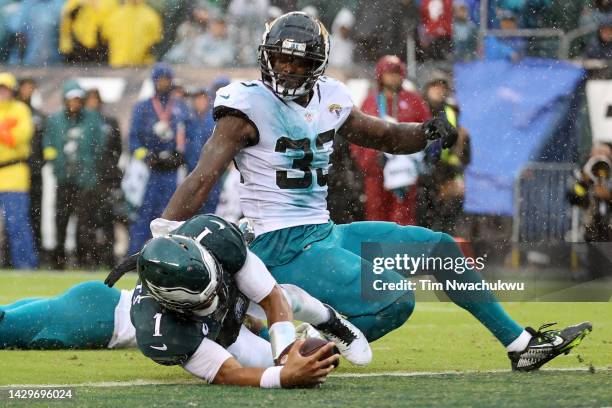 Jalen Hurts of the Philadelphia Eagles dives past Devin Lloyd of the Jacksonville Jaguars while scoring a touchdown during the second quarter at...