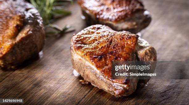 roasted duck breast on a cutting board ready for slicing and serving. - ankbröst bildbanksfoton och bilder