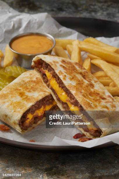double bacon cheese burger crunch  wrap - onion family stock pictures, royalty-free photos & images
