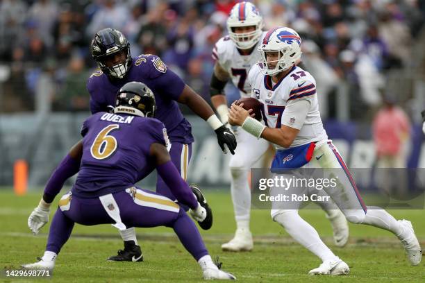 Josh Allen of the Buffalo Bills runs with the ball while being chased by Patrick Queen of the Baltimore Ravens in the second quarter at M&T Bank...