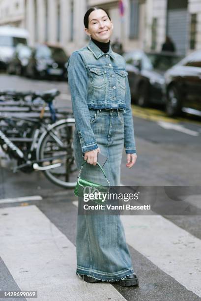 Clara cornet poses wearing a denim jacket, a denim long skirt and a Valentino embroided green bag after the Valentino show at the Carreau du Temple...