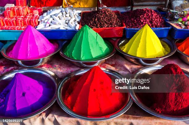 conical piles of kumkum coloured powder - poder stock pictures, royalty-free photos & images