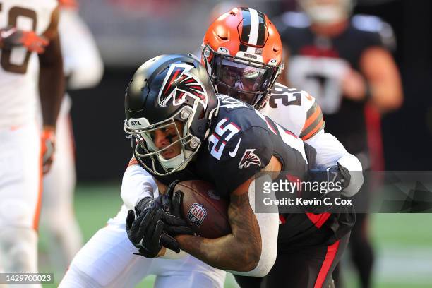 Tyler Allgeier of the Atlanta Falcons runs with the ball against Jeremiah Owusu-Koramoah of the Cleveland Browns during the first quarter at...
