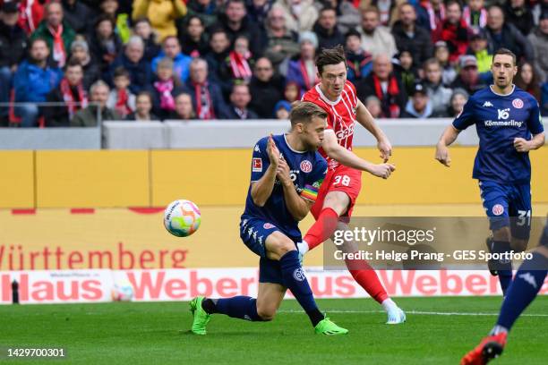 Michael Gregoritsch of Freiburg scores his team's first goal against Silvan Widmer of Mainz during the Bundesliga match between Sport-Club Freiburg...