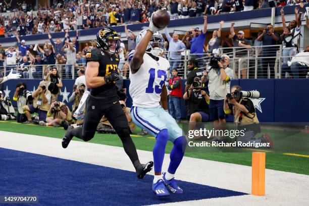 Michael Gallup of the Dallas Cowboys celebrates after scoring a touchdown past Cole Holcomb of the Washington Commanders during the second quarter at...
