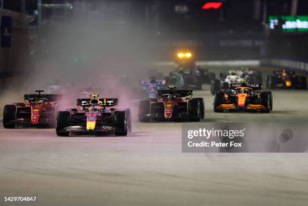 Sergio Perez of Mexico and Red Bull Racing leads at the start during the F1 Grand Prix of Singapore at Marina Bay Street Circuit on October 02, 2022...