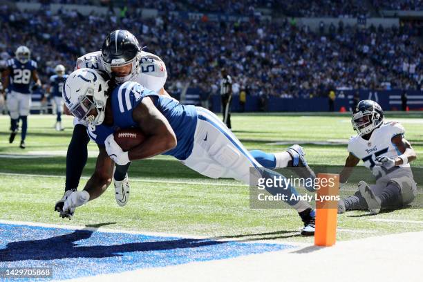 Dylan Cole of the Tennessee Titans tackles Mo Alie-Cox of the Indianapolis Colts as Alie-Cox scores a touchdown during the second quarter at Lucas...