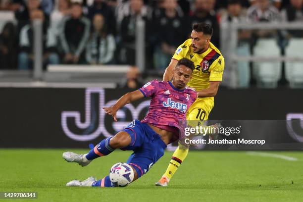 Danilo of Juventus is pulled back by Nicola Sansone of Bologna FC during the Serie A match between Juventus and Bologna FC at Allianz Stadium on...