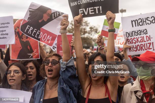 People hold signs and chant slogans during a protest against the death of Iranian Mahsa Amini and the government of Iran on October 02, 2022 in...