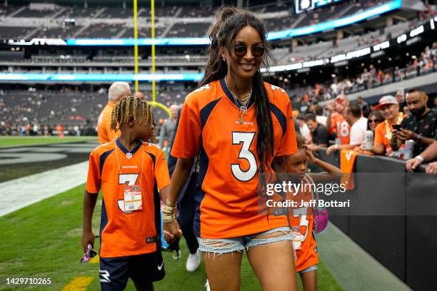 Future Zahir Wilburn, Ciara Wilson, wife of Russell Wilson of the Denver Broncos, and Sienna Princess Wilson walk across the field before the game...